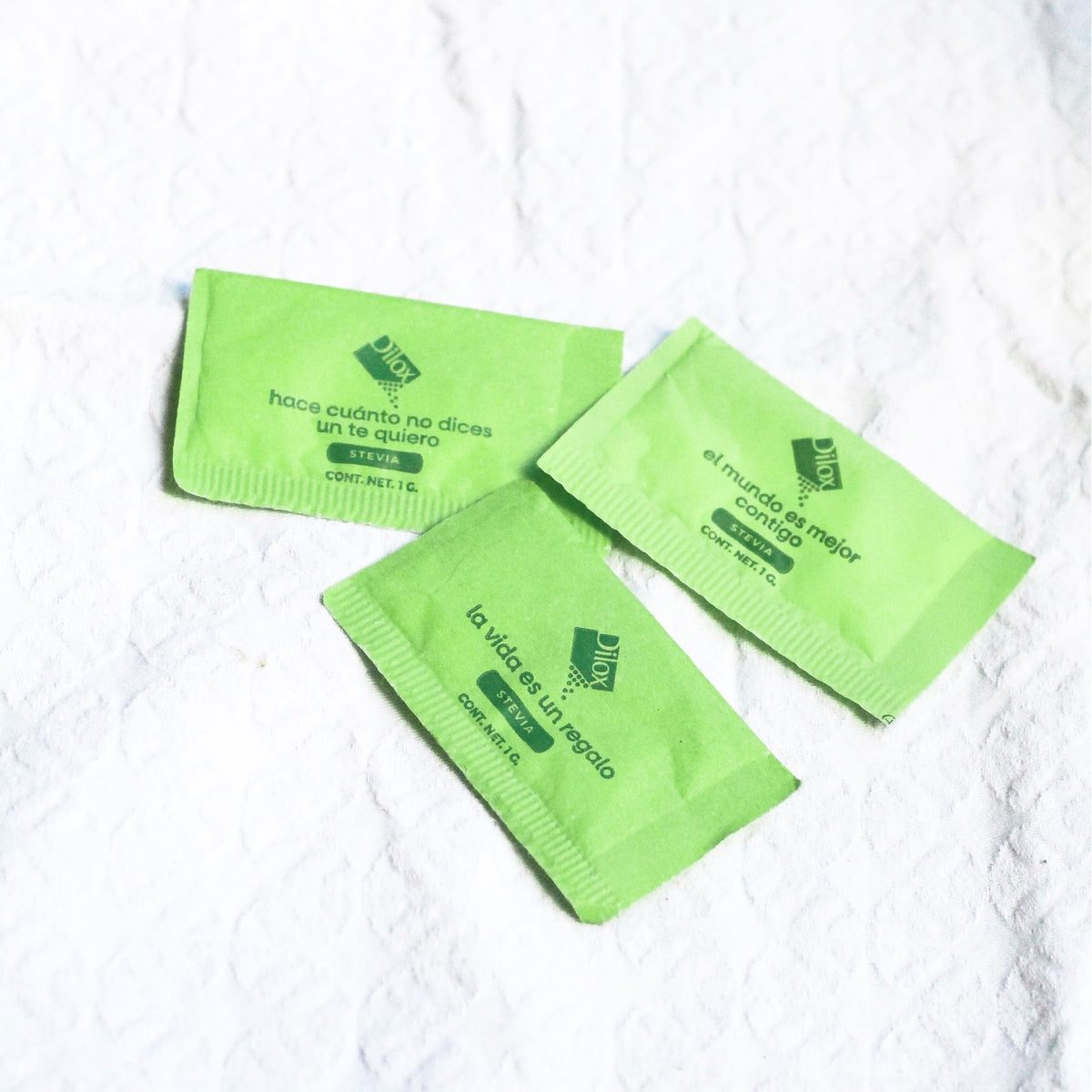 Tres sobres de stevia Dilox de 1 g sobre mantel blanco